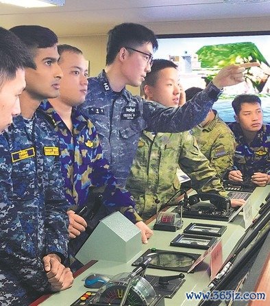 外国军官和中方学员在模拟驾驶室共同完成舰艇靠泊训练。本报记者　张　丹摄